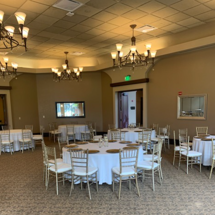 a hotel event ballroom set up with rented tables and chairs